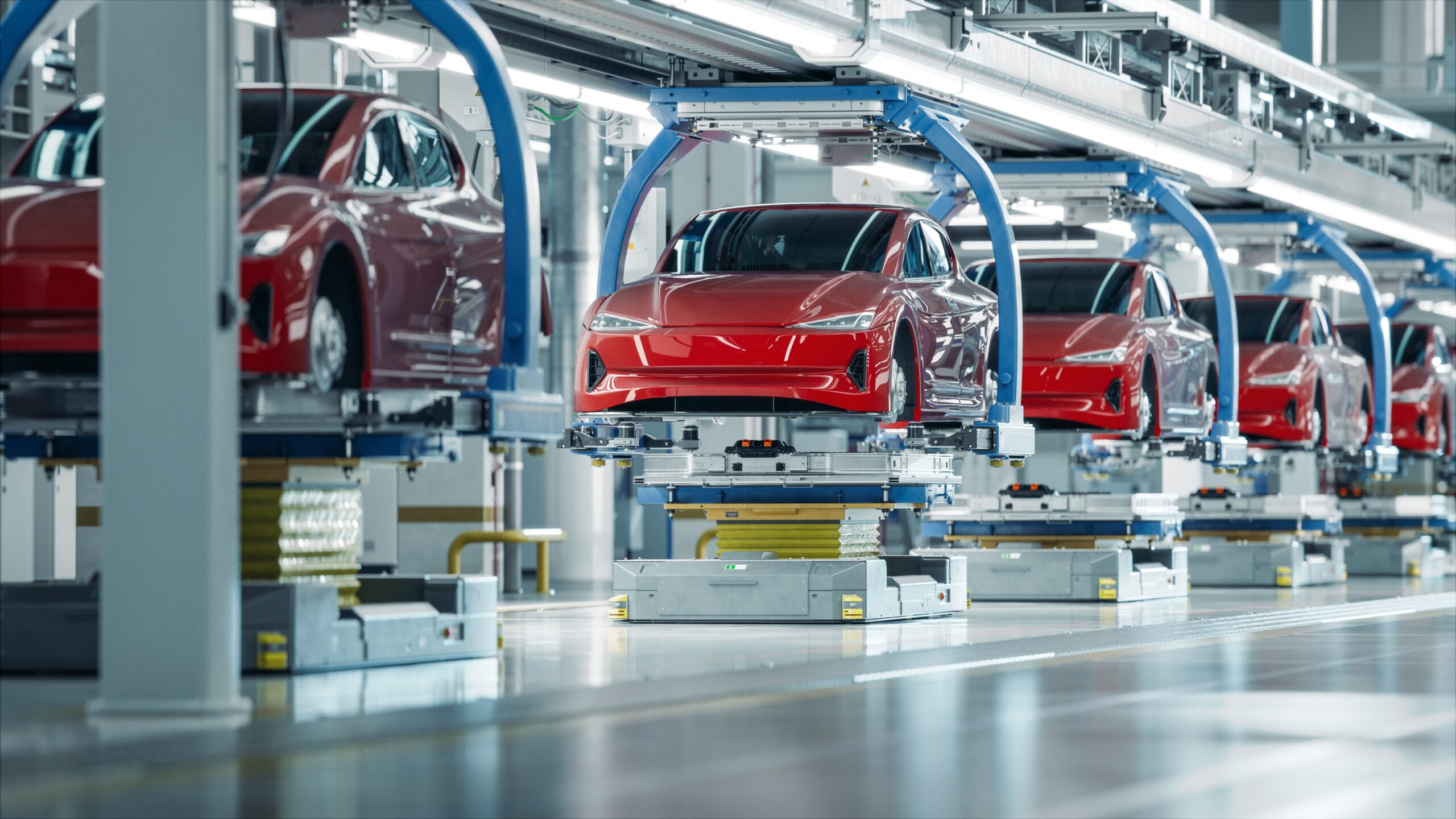 Multiple red diesel vehicles on an automated production line, symbolising cars affected by diesel emissions claims.