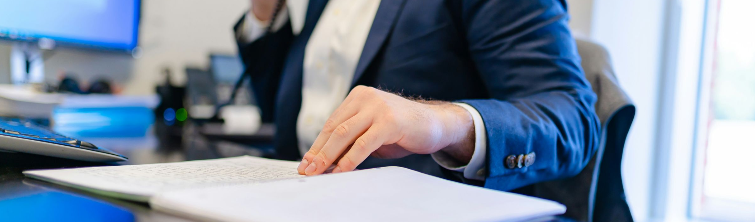Man on phone and computer processing mis-sold car finance claim – car finance Supreme Court case response