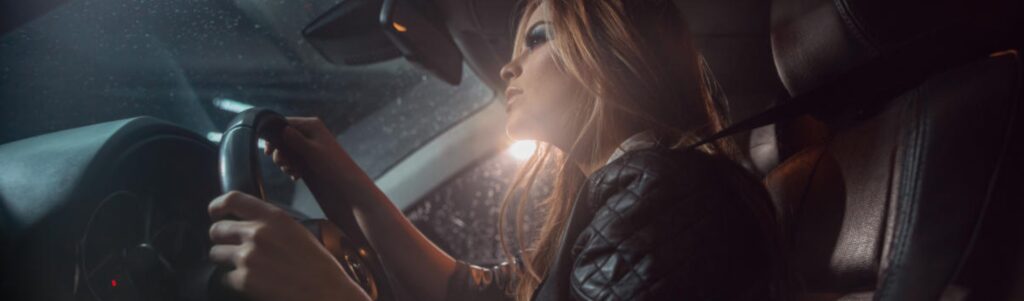Black Horse car finance claim. Woman sits in car at night in the rain after being mis-sold finance. Learn how to claim compensation.